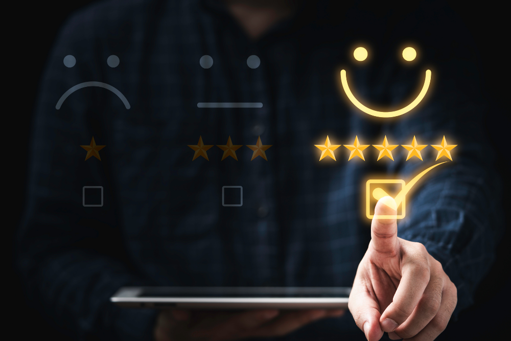 User rating feedback with smiley face and star icons on digital tablet.