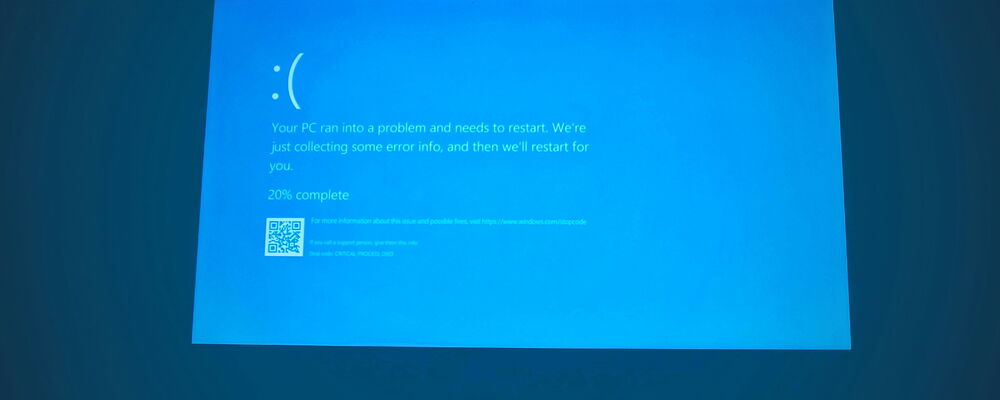 Windows error message on blue screen indicating restart needed.