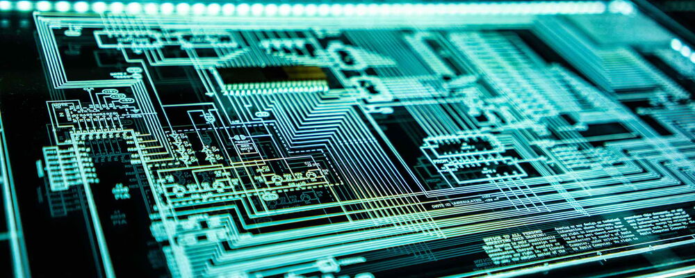 A glowing digital circuit board design displayed on a high-tech screen, featuring intricate pathways, nodes, and components. The image highlights the complexity of electronic systems and technology, with a futuristic and sleek appearance.