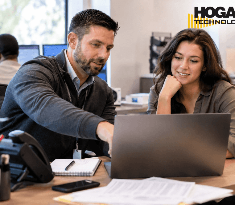 Employees collaborating on technology solutions in a modern office environment.